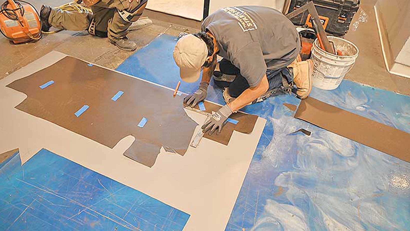 slider-photo-of-flooring-apprentice-measuring-material